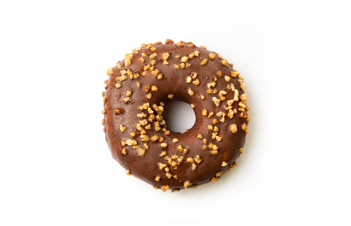 Chocolate glazed donut topped with crunchy nuts