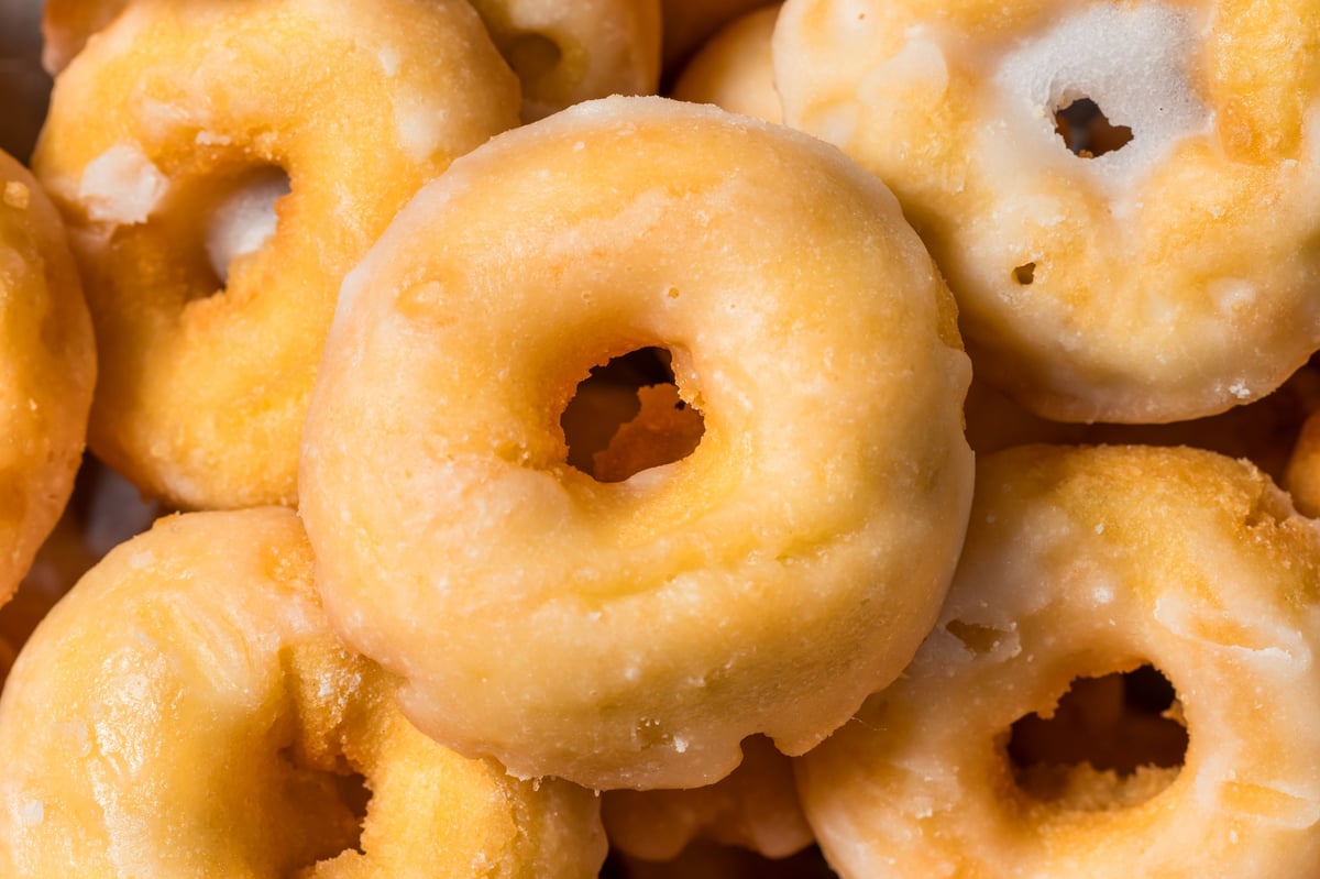 Homemade mini glazed old fashioned donuts in a pile
